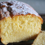 Homemade lemon drizzle loaf cake cooling on rack