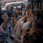 A woman holds her baby